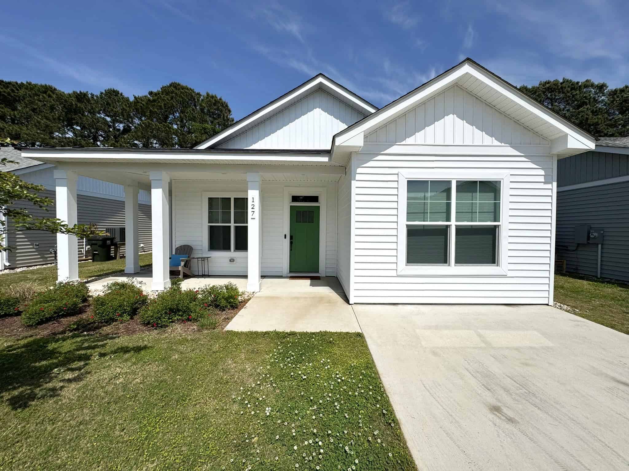 a white house with a green door